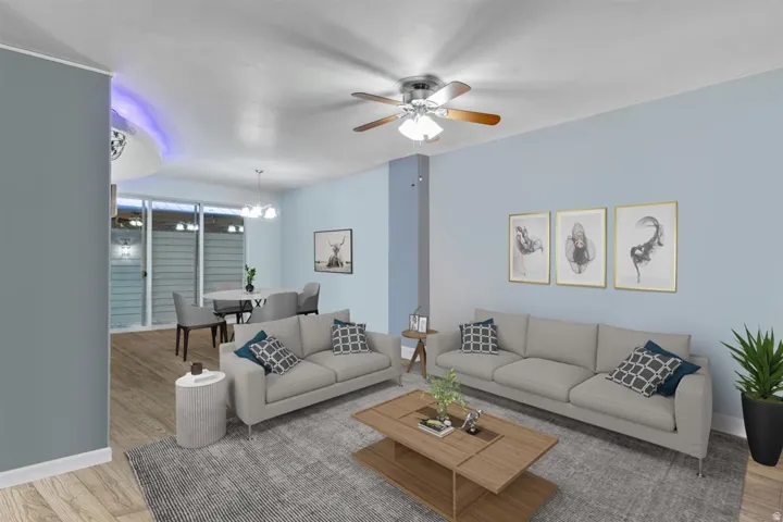 Open-concept living space featuring wood-finish flooring, recessed lighting, and a ceiling fan with light kit