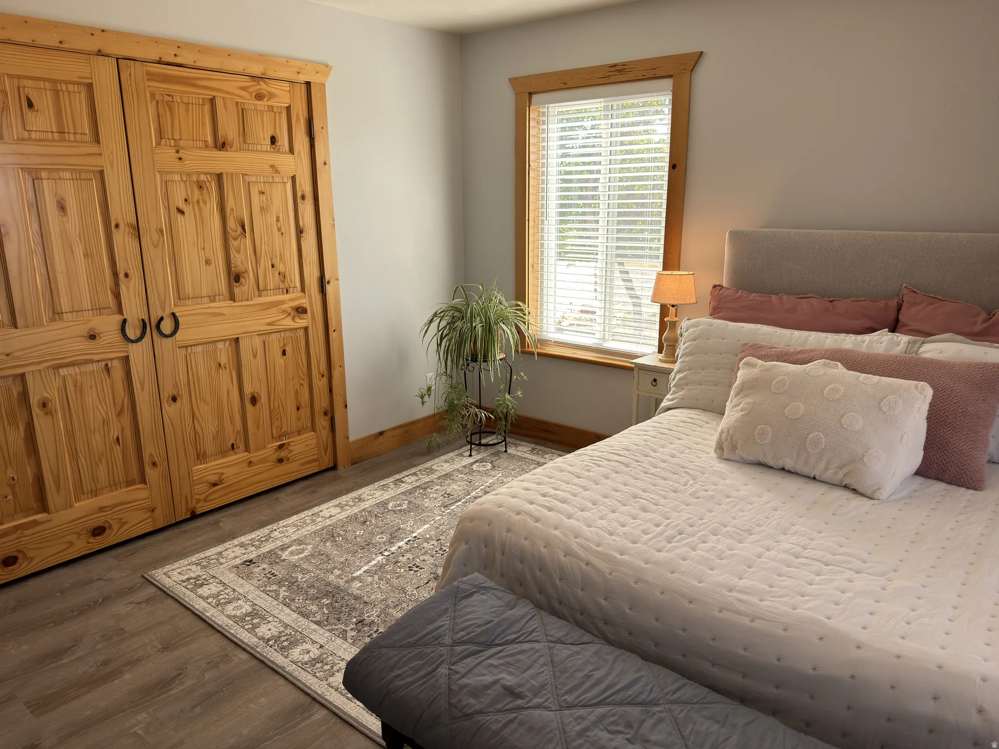 Bedroom featuring solid stain grade wood french doors with custom black hardware