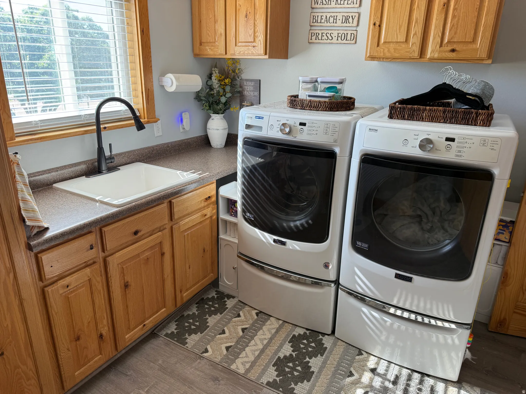 Dedicated laundry area featuring a built-in utility sink with a gooseneck faucet