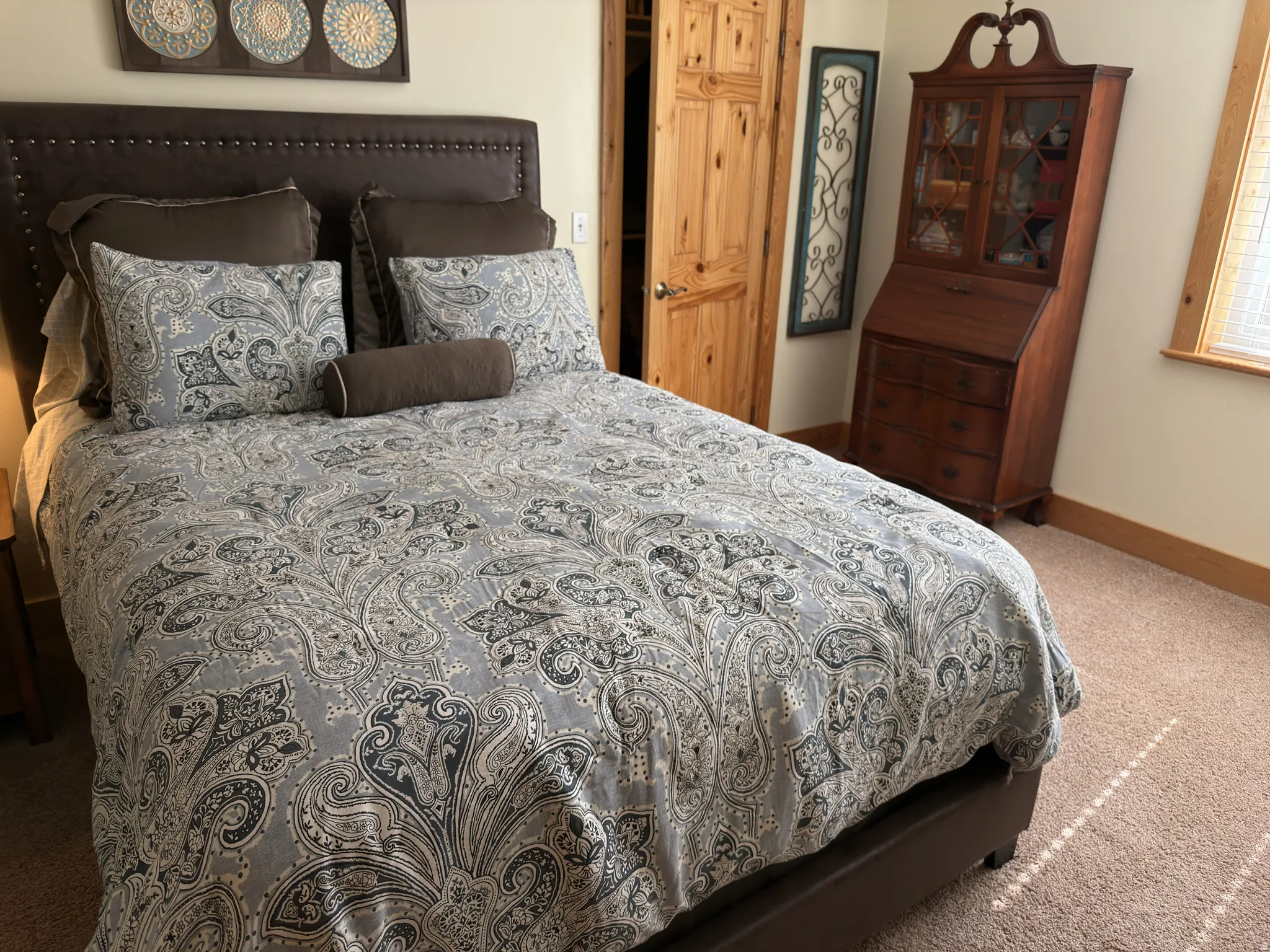 Carpeted room featuring a solid wood door.