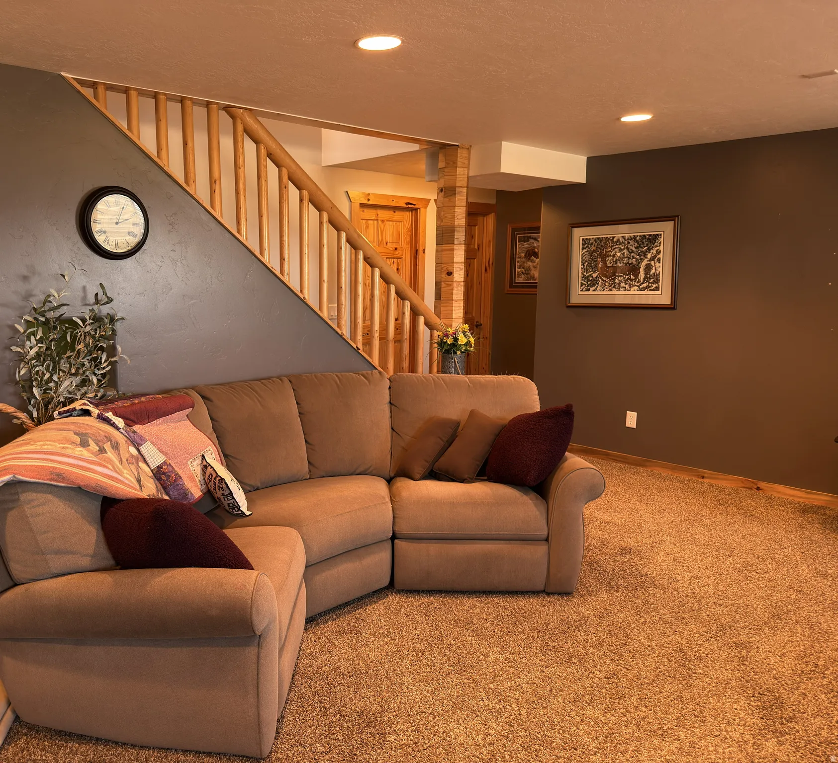 Inviting living area featuring a custom log banister staircase