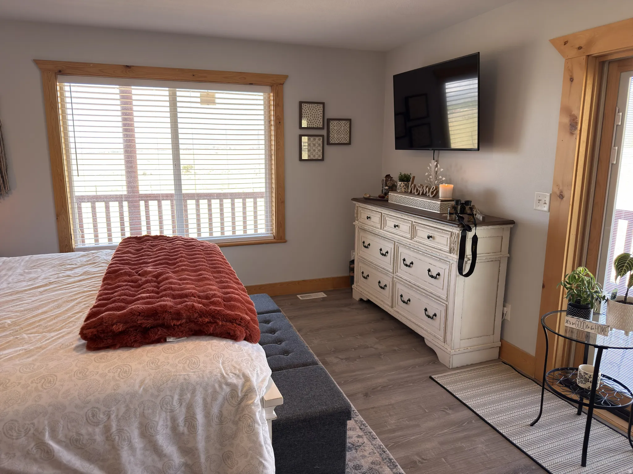 Spacious room featuring laminate flooring and a large window with wood trim