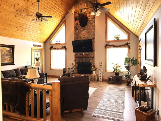 Vaulted tongue and groove wood ceiling featuring fans and recessed lighting