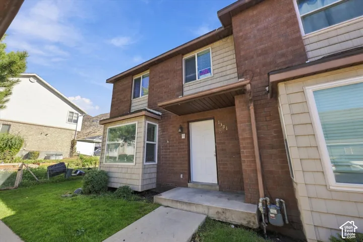 Brick and shingle exterior with a covered entry