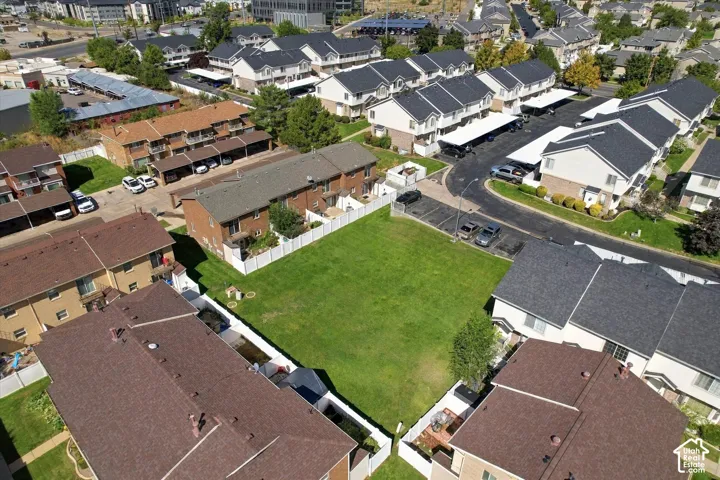 Expansive green space with perimeter fencing surrounded by residential structures