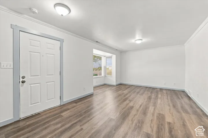 Wood-finish flooring throughout, bay window, and contemporary ceiling light fixtures