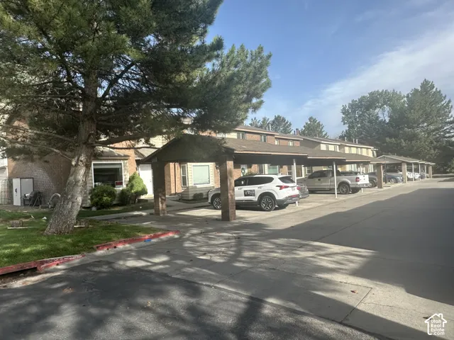 2 carport in front of the house assigned. Additionally parker space for visitorsMultiple carport spaces with metal framing and pitched roofs