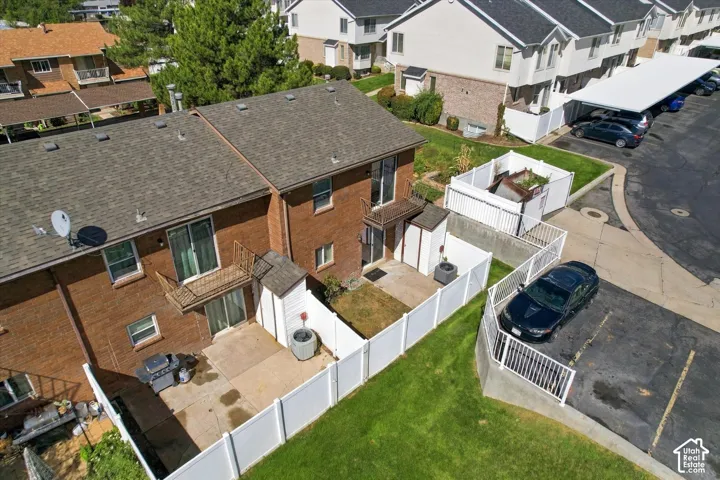 Drone BackviewBrick exterior with private patio, fenced yard, and second-story balcony