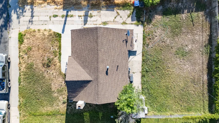 Brown shingle roofing with chimney and visible satellite dish
