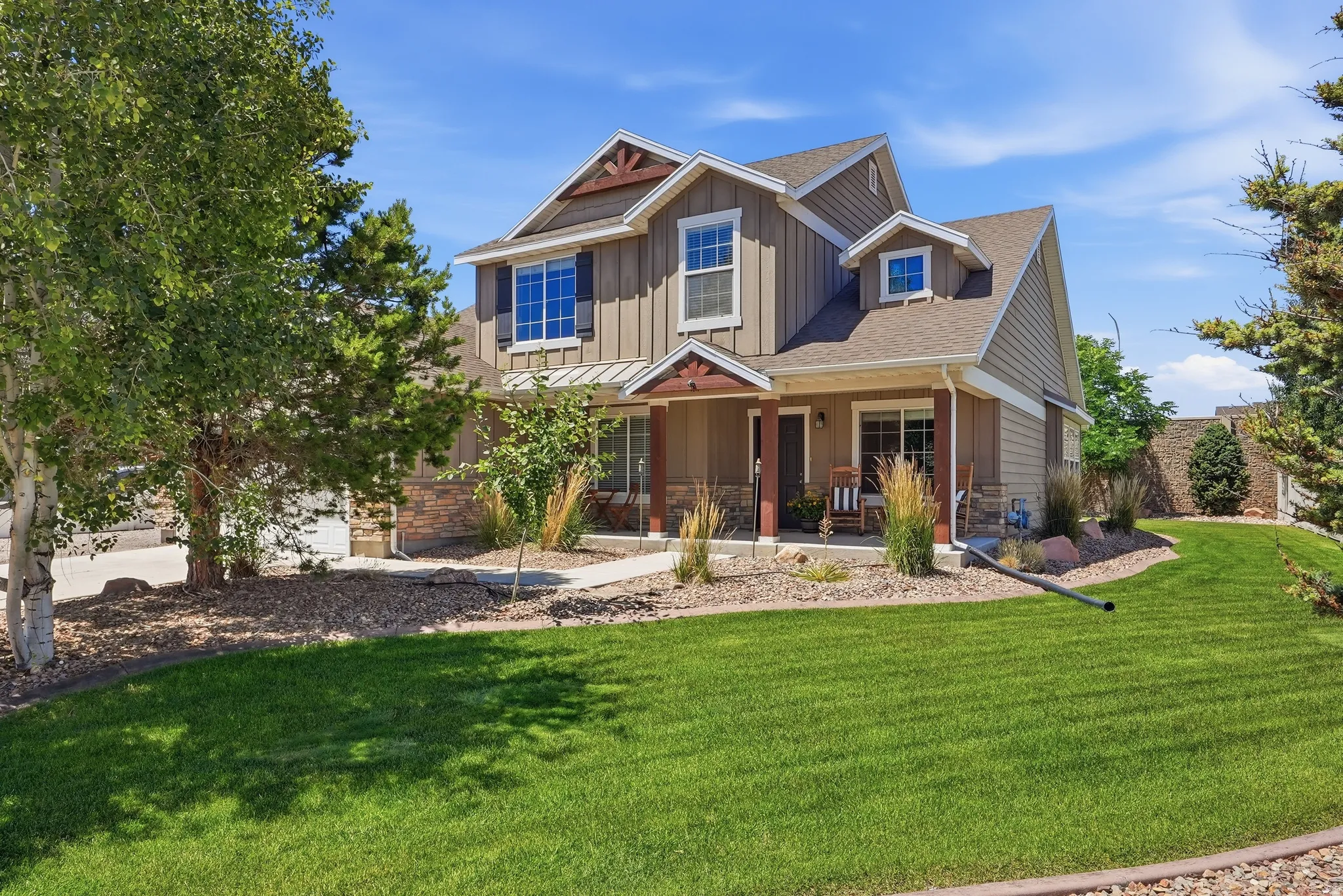 Craftsman-style home featuring a covered front porch with wood columns and stone accents
