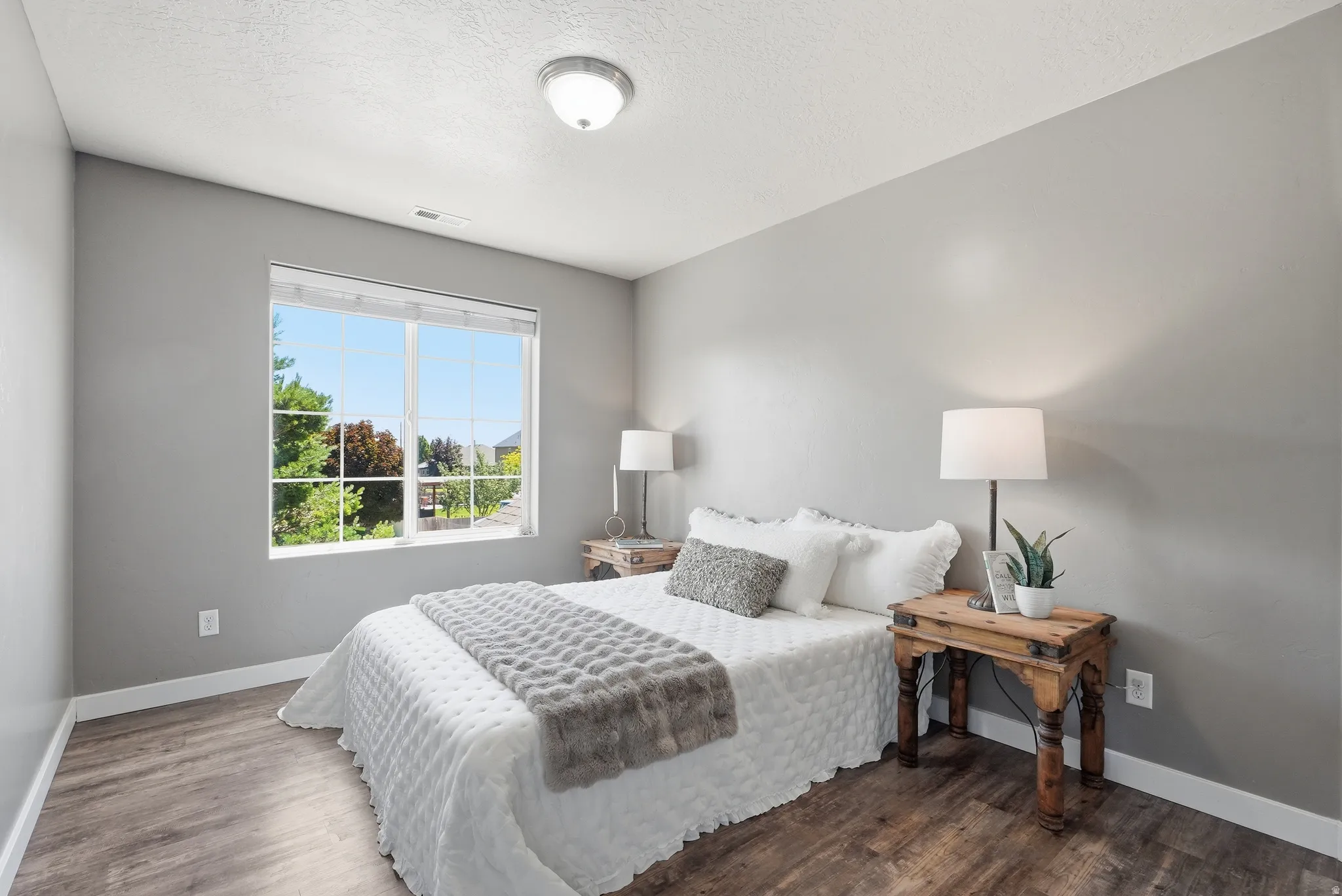 Spacious room featuring wood-finish flooring, large closet and large window