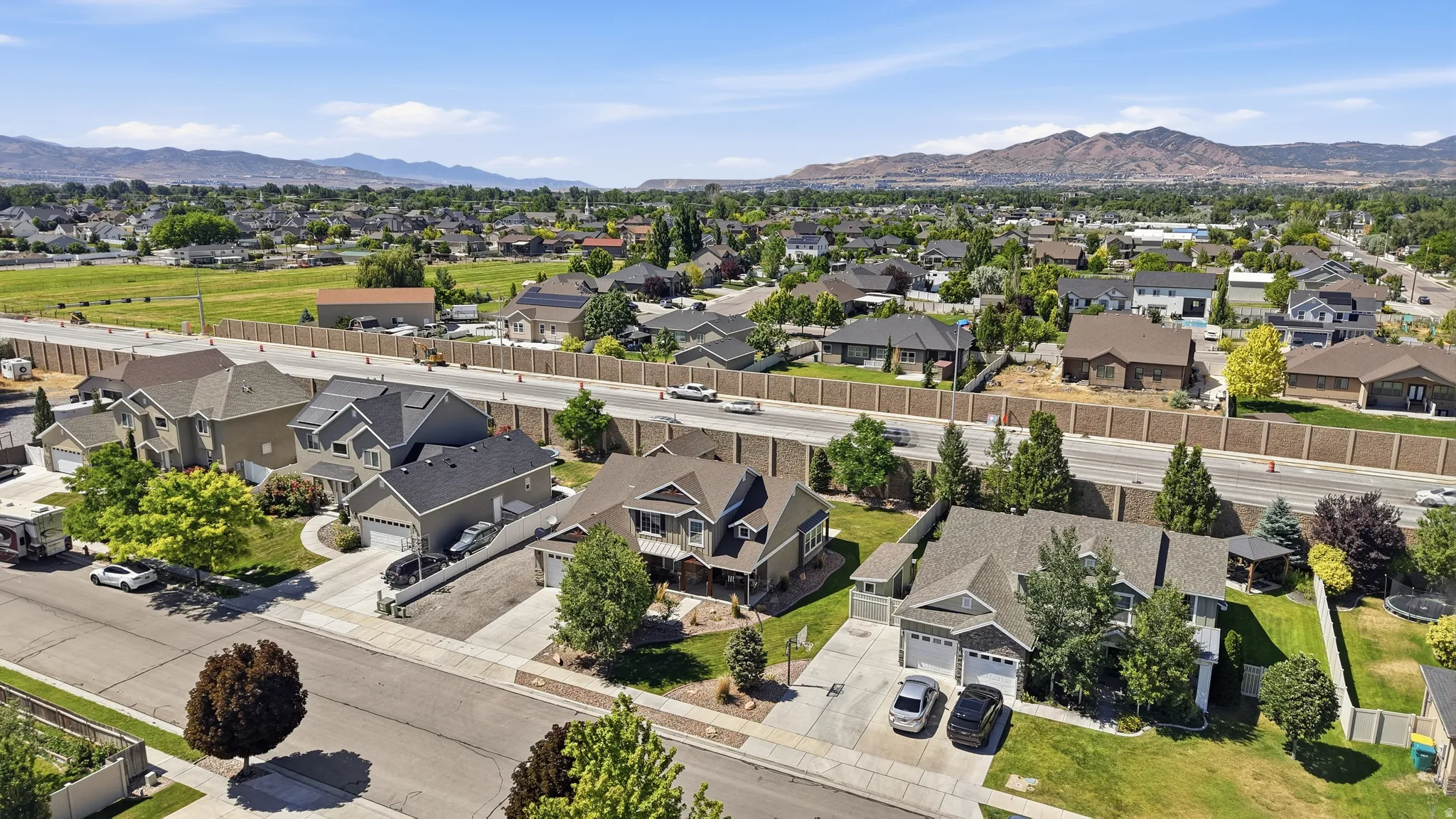Residential neighborhood featuring single-family homes with pitched roofs and attached garages
