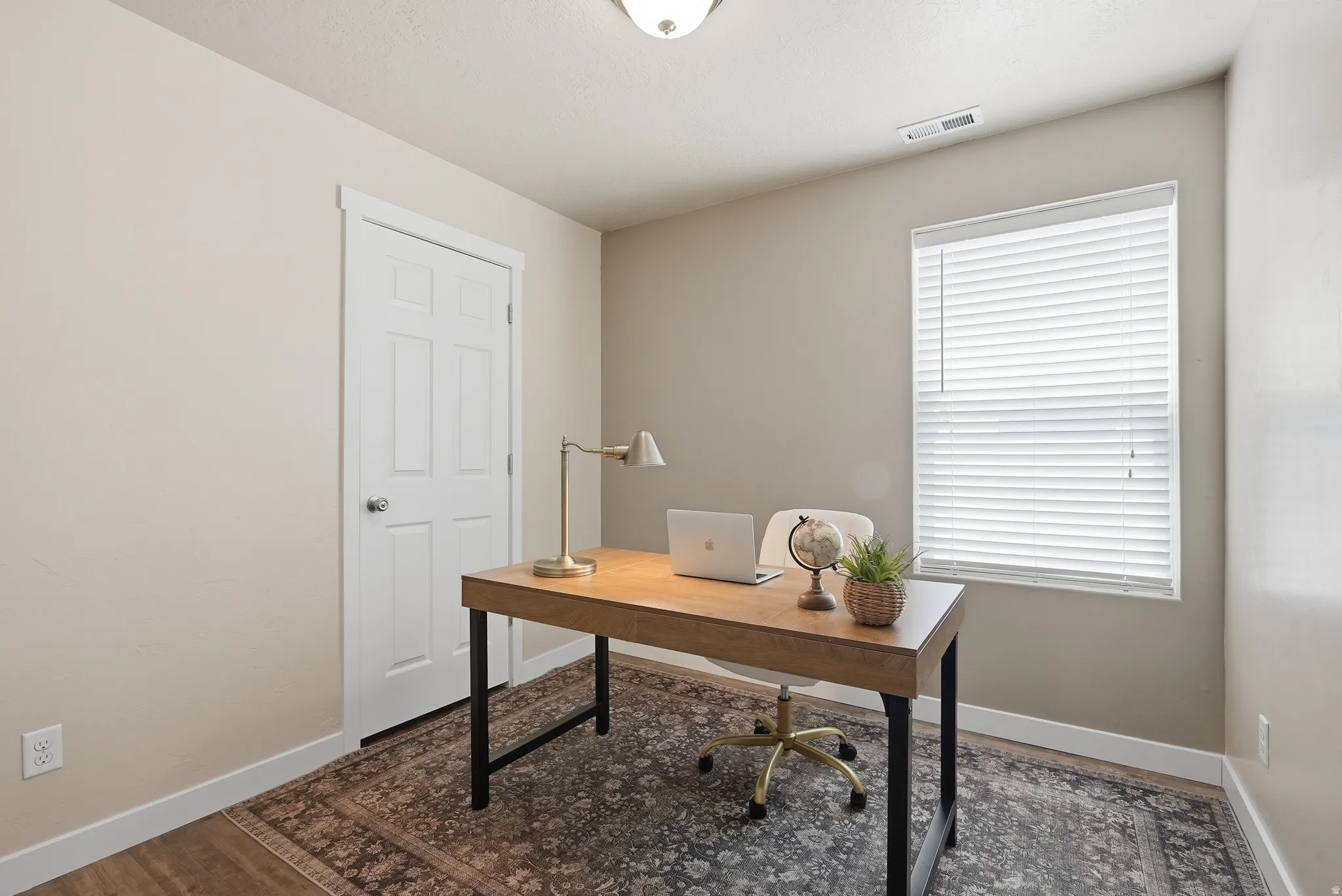 Bedroom/Office featuring a wood-finish floor and a white paneled door
