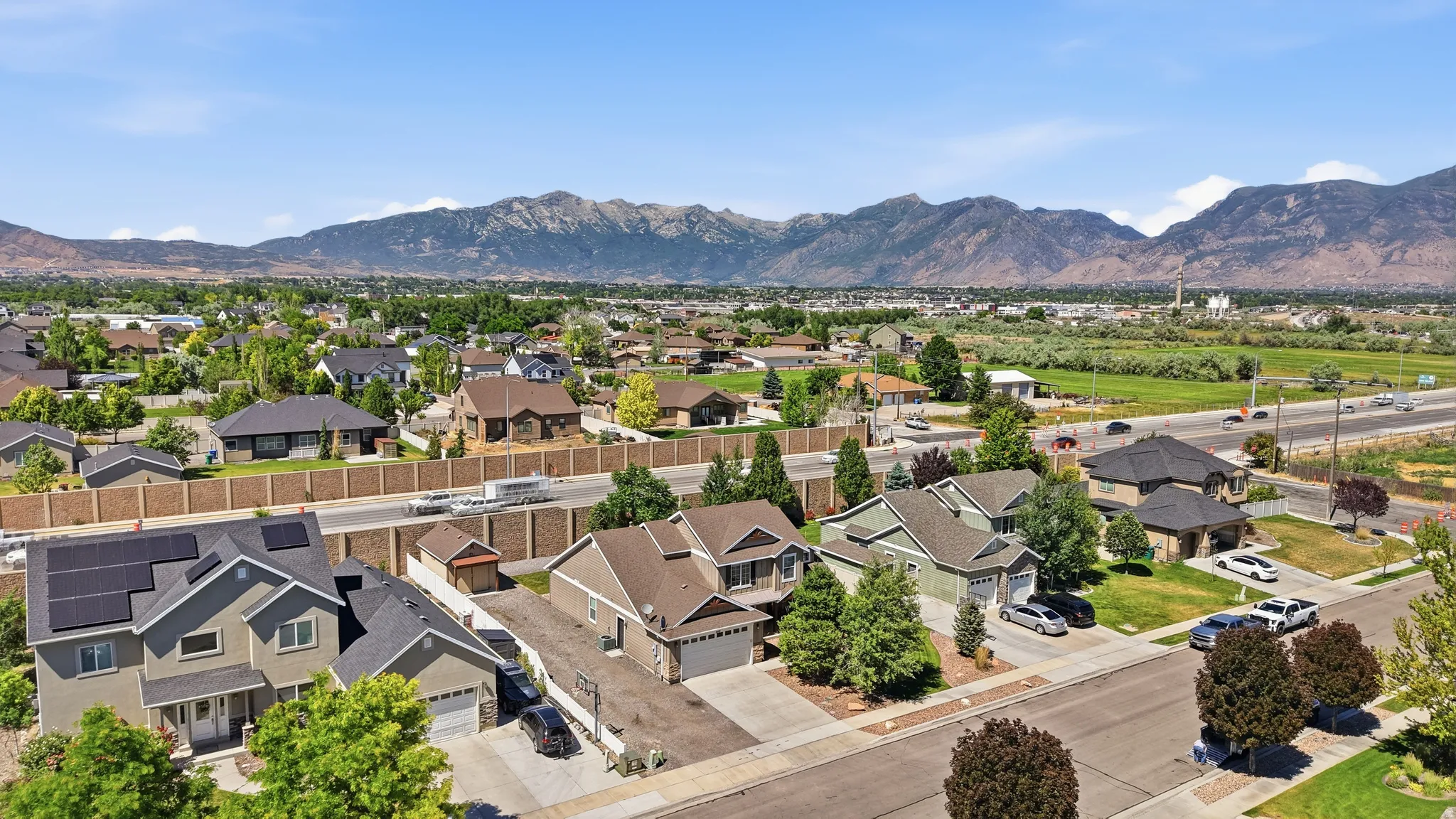 Residential neighborhood with mature trees and mountain scenery
