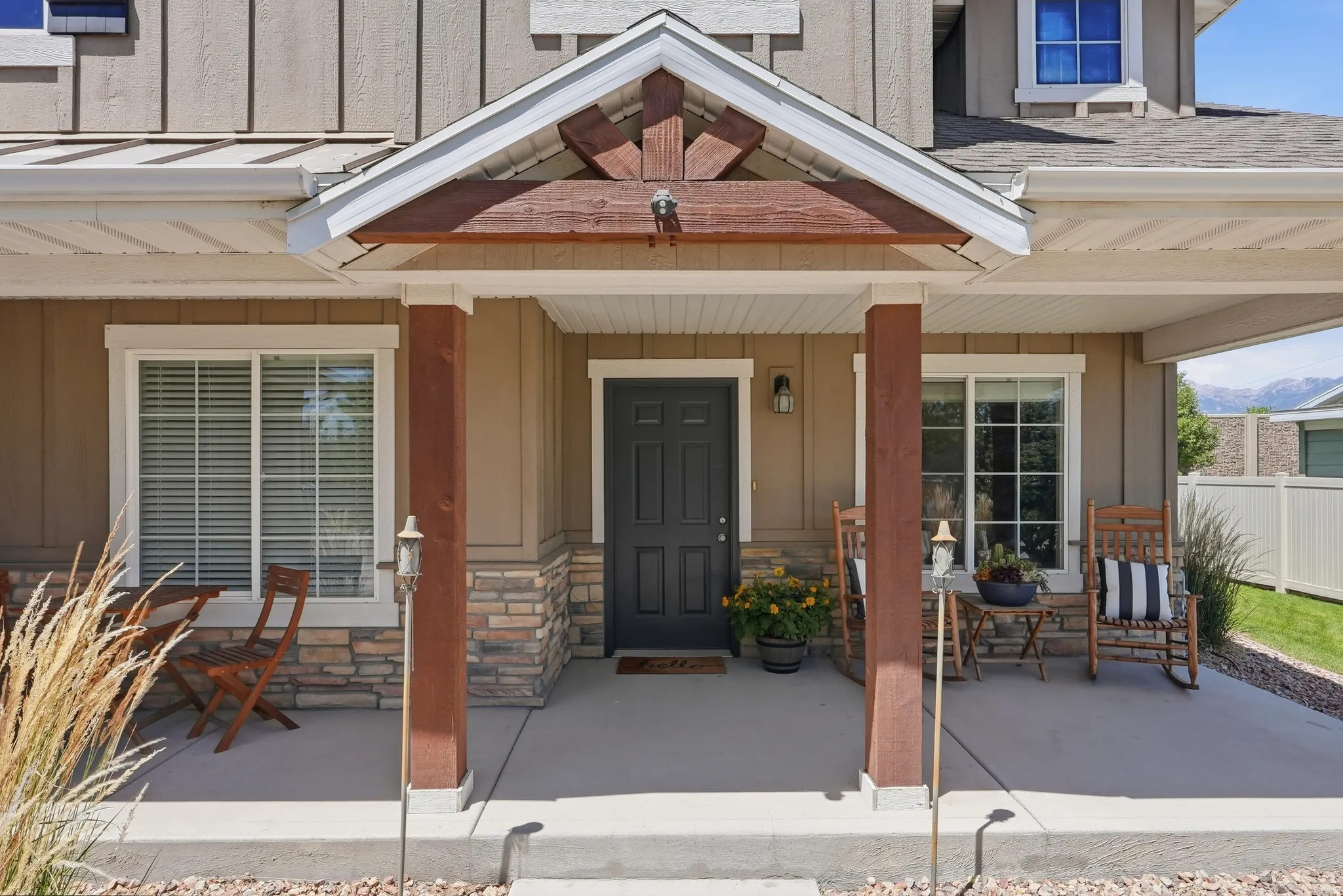 Inviting covered porch entry with stone accents and sturdy columns