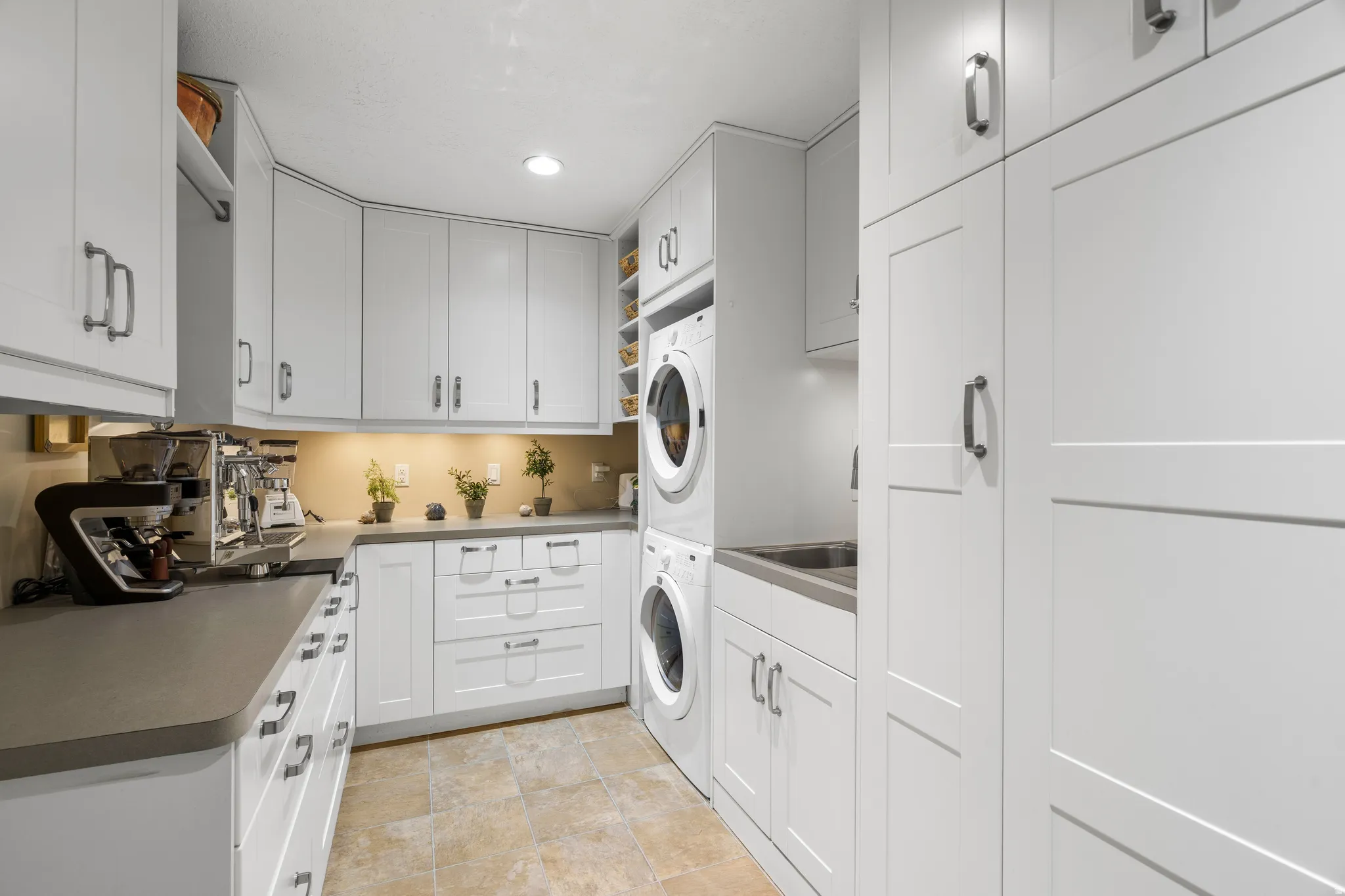 Well designed butlers pantry/laundry with custom cabinets counter space for a barista station