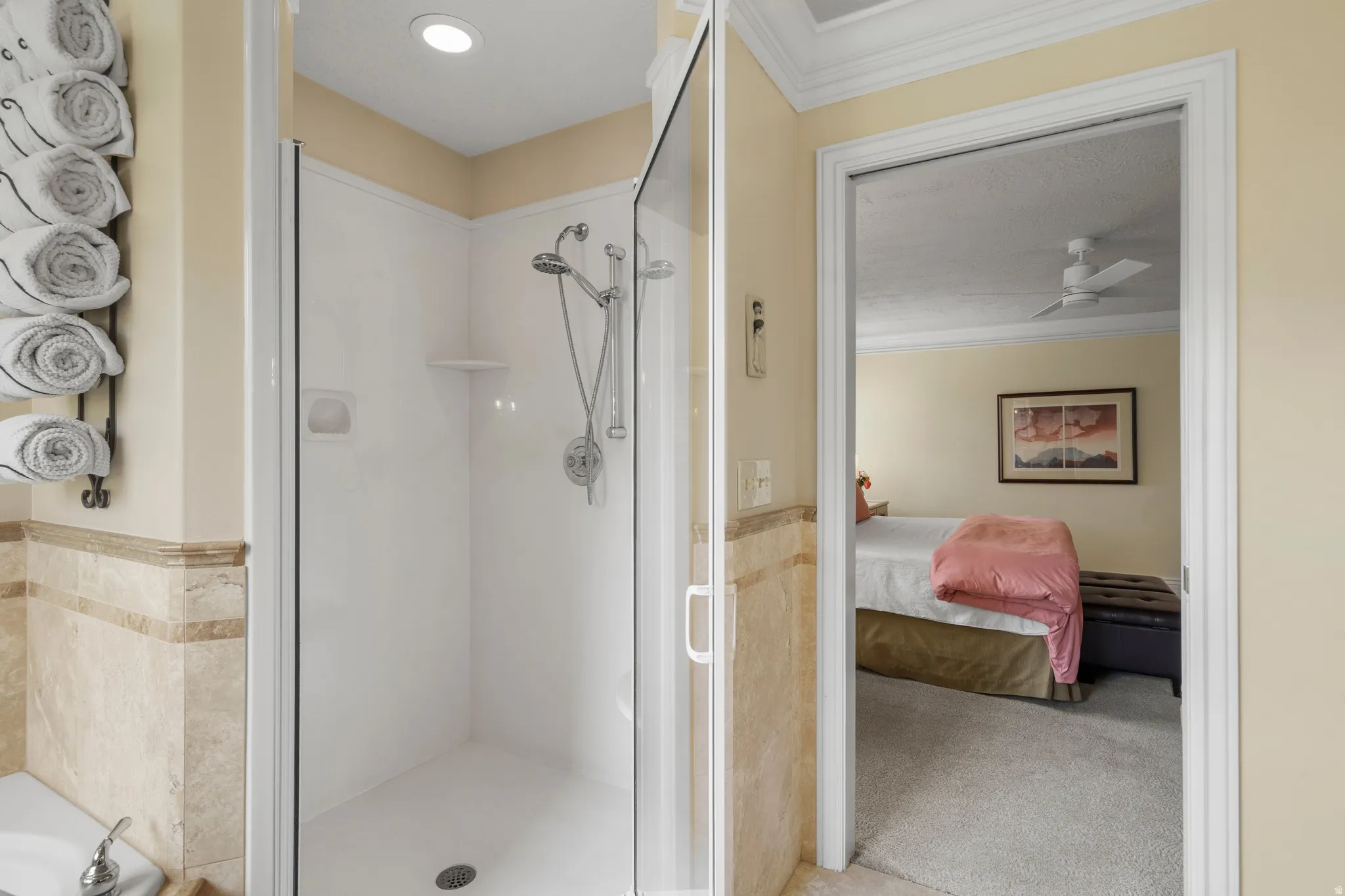 As you walk in to the primary bathroom glass-enclosed shower