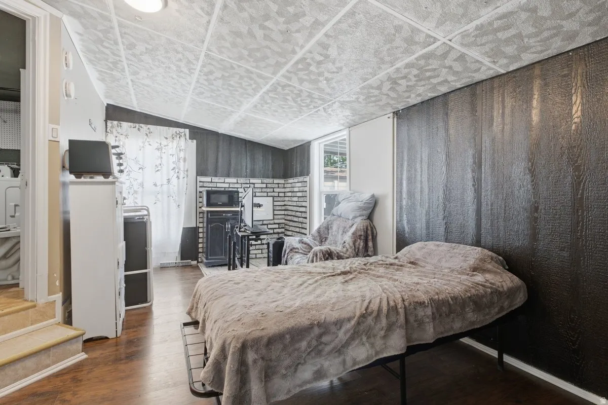 Bedroom #3, ADC?   set up with its own mini kitchen.  wood-finish flooring with dark paneling and a tiled ceiling