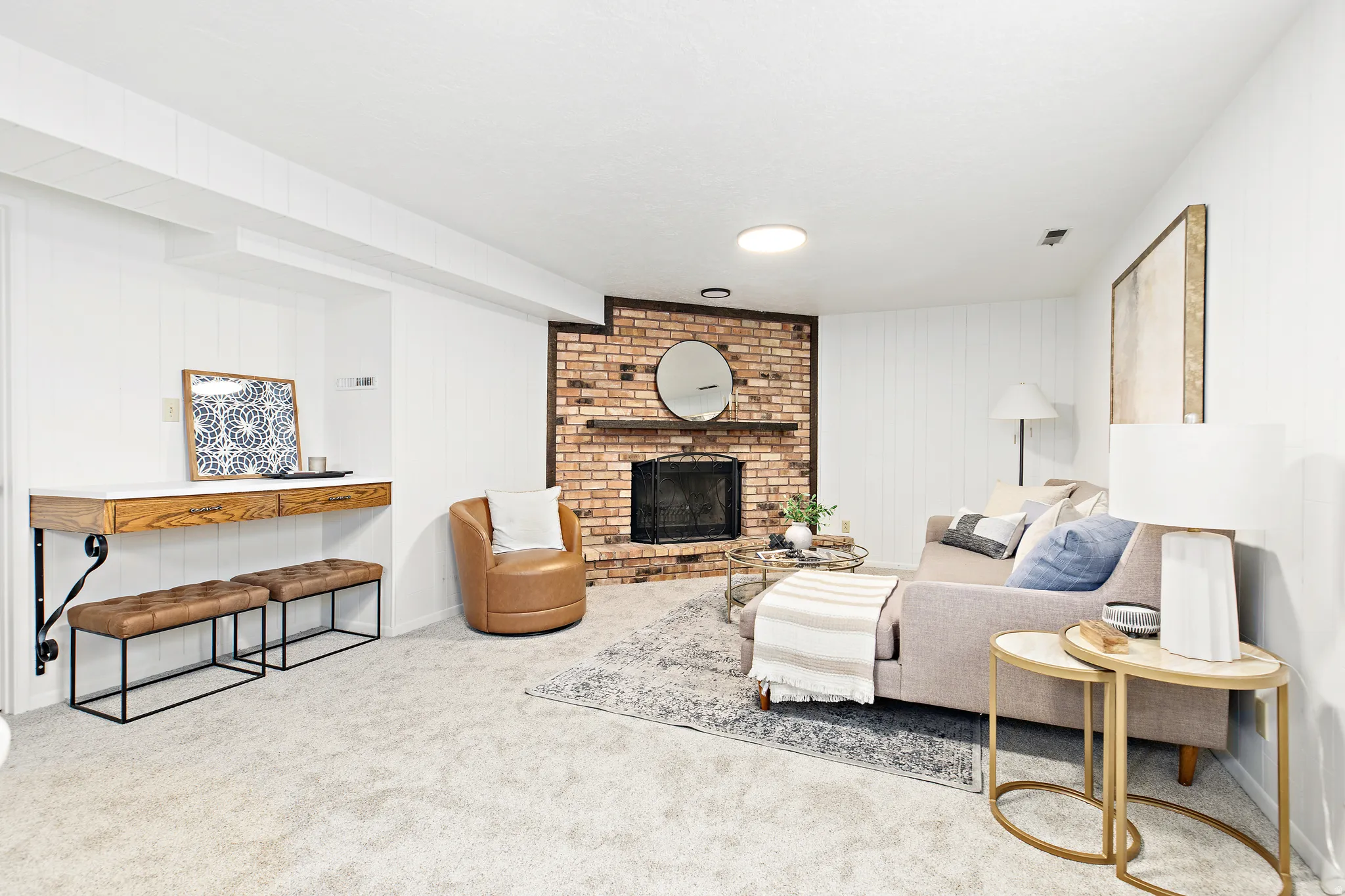 Exposed brick fireplace with a wood mantle