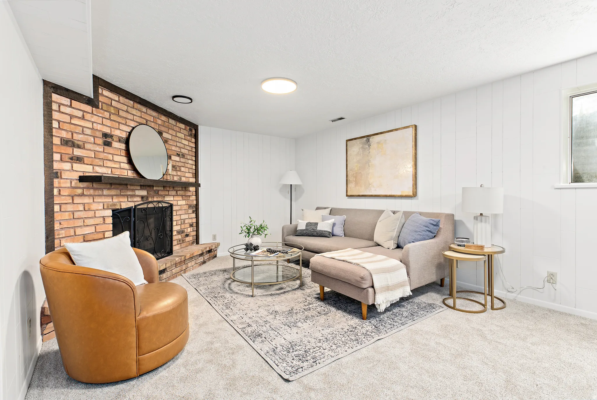 Living area featuring a brick fireplace with a dark wood mantel and hearth