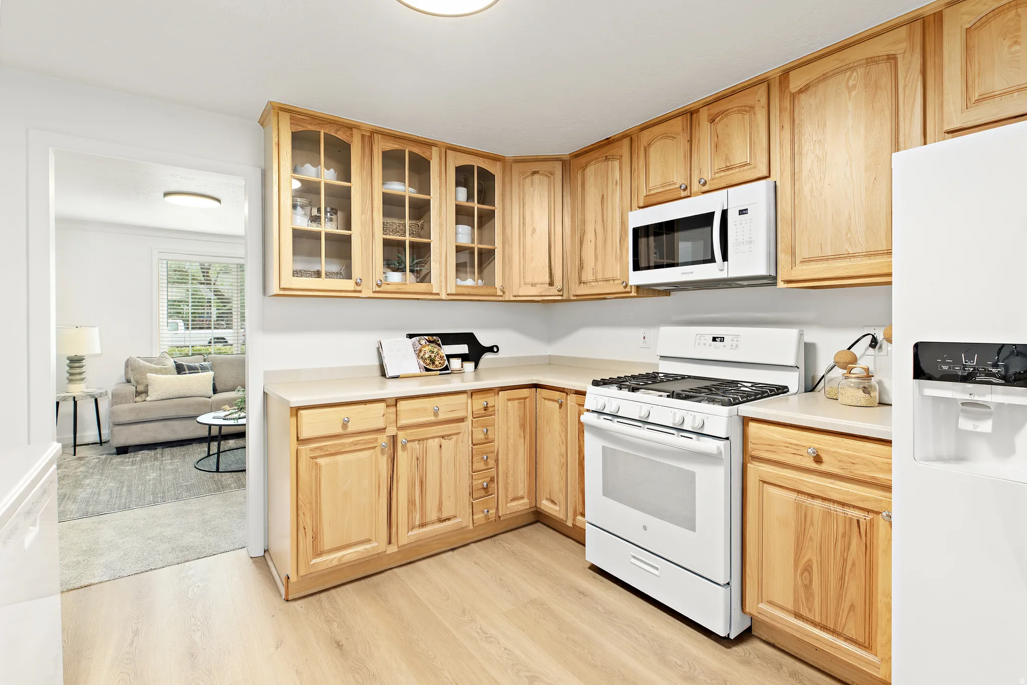 Kitchen featuring light wood-finish cabinetry, light countertops, and light wood-finish flooring