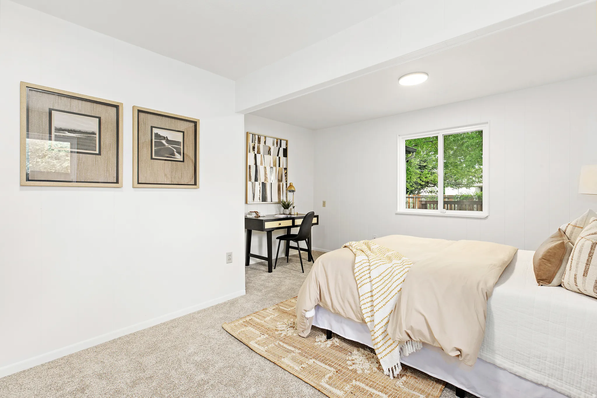 Spacious room with light neutral carpet and white walls