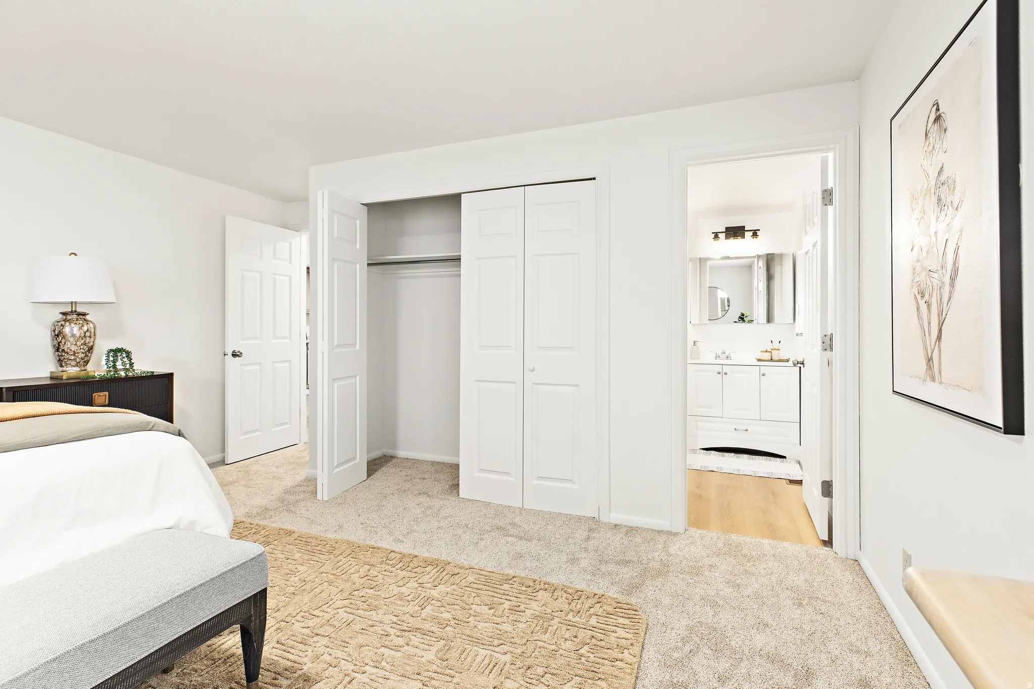 Carpeted room with white walls and a bi-fold closet