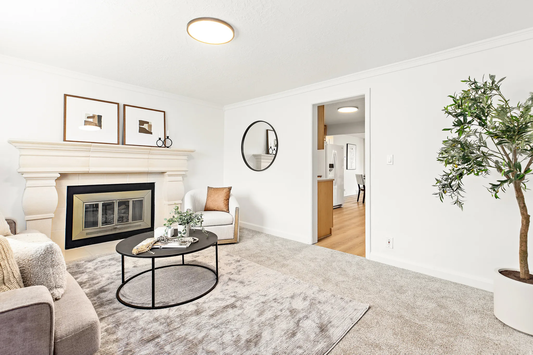 Living area featuring a stone mantel fireplace with an ornate firebox, crown molding, and ceiling-mounted lighting
