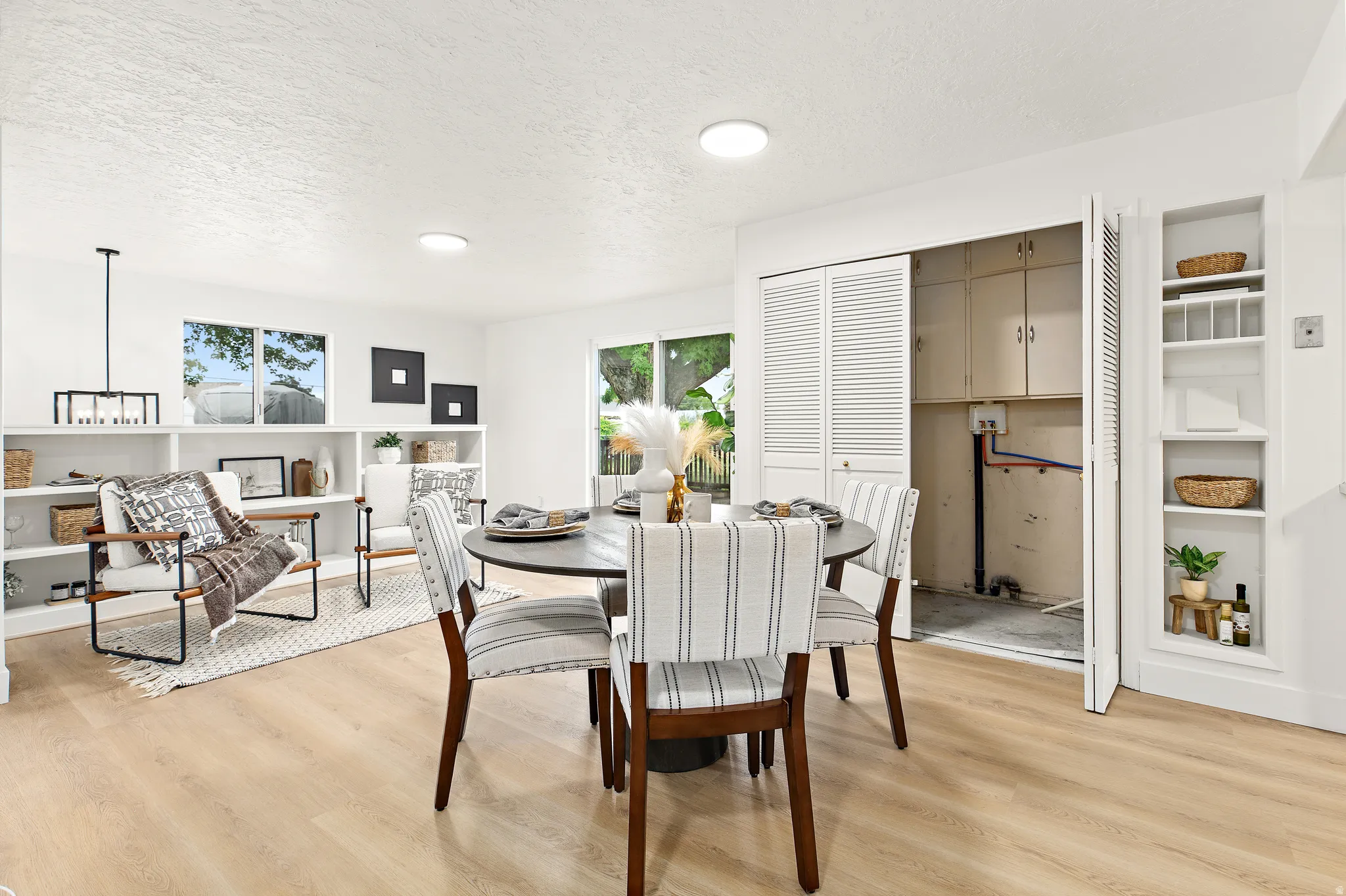 Light wood-finish flooring extending throughout the open-concept space