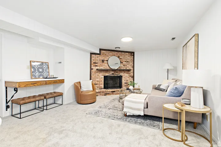 Exposed brick fireplace with a wood mantle