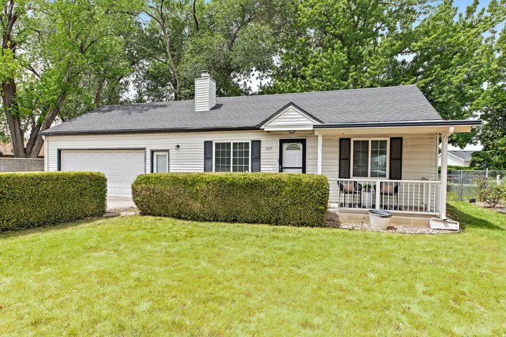 Cream-colored siding exterior with a dark gray asphalt shingle roof