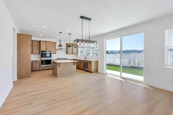 Open-concept living space with wood-finish flooring