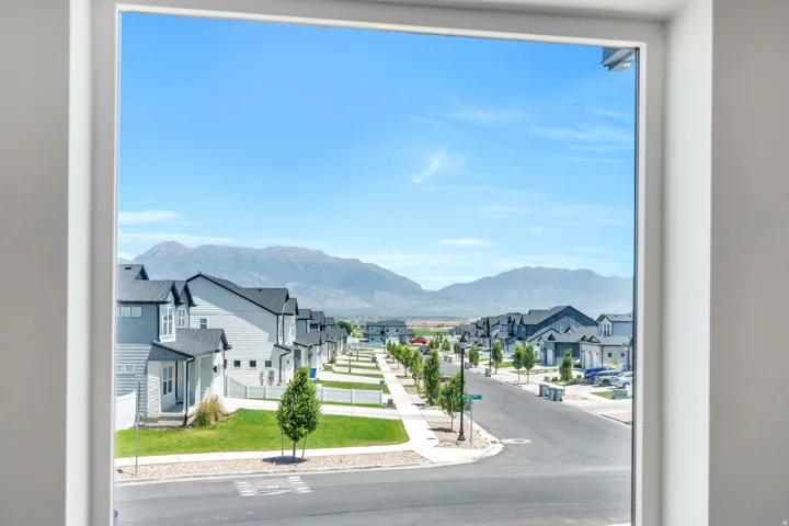 Expansive window framing streetscape with mountain backdrop
