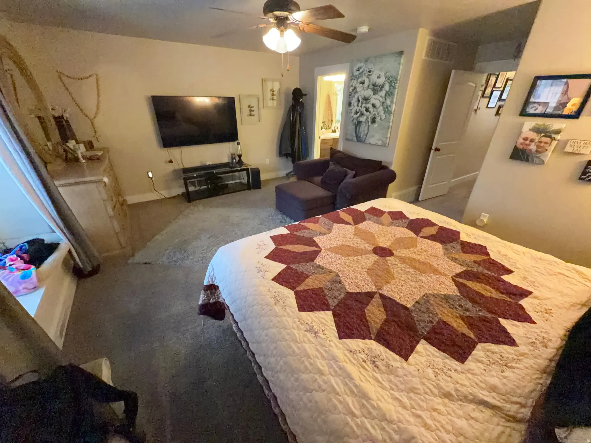 Spacious room featuring carpeting, ceiling fan with light fixture, and a built-in window seat