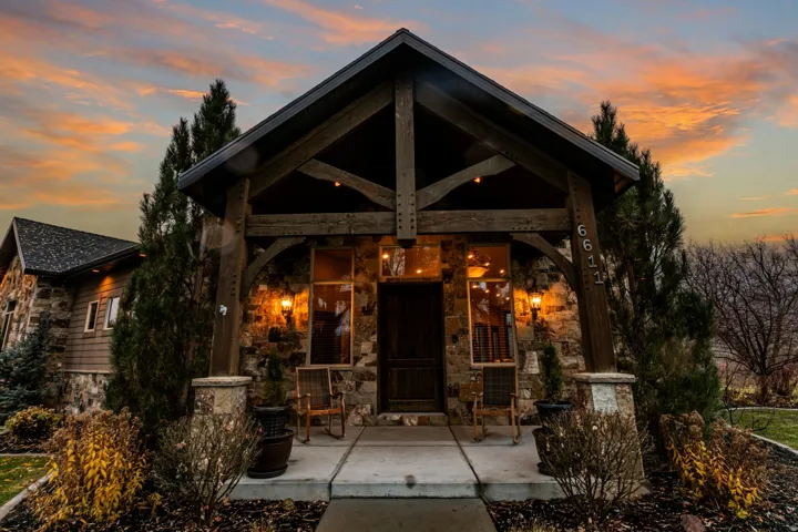Stone and wood-clad exterior with exposed timber framing and a covered entry