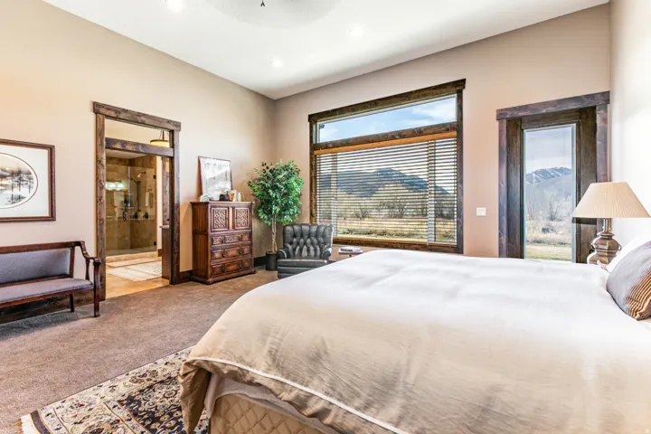 Carpeted interior space featuring extensive window and door framing, a large glass pane window with blinds, a glass pane door, and a recessed ceiling light