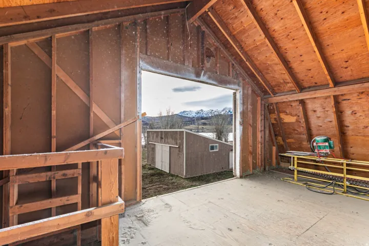 Open structure with exposed wood framing and a pitched roof