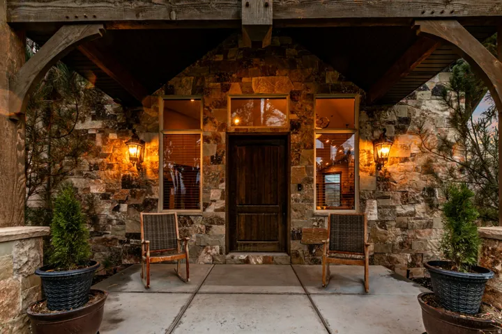 Stone veneer facade with a wood-paneled entry door