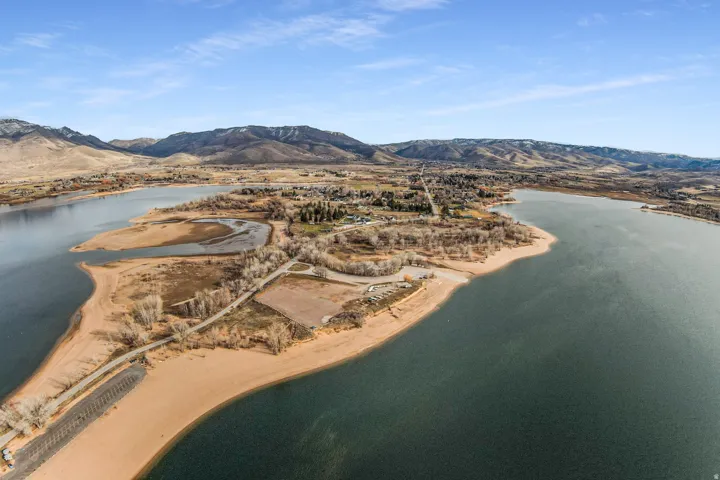 Expansive aerial perspective showcasing a significant body of water bordered by sandy shorelines
