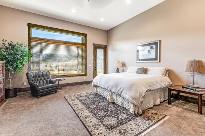 Room featuring a large picture window with mountain scenery, recessed ceiling lighting, and a wood-framed glass door