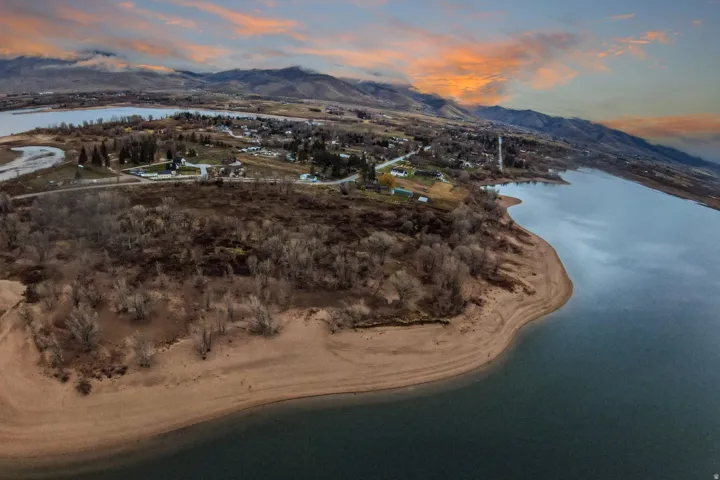 Expansive waterfront property featuring a sandy shoreline and direct water access