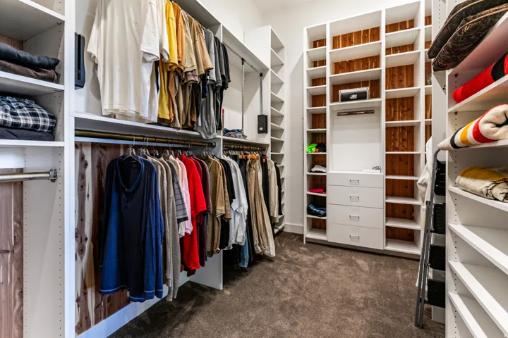Custom closet system featuring extensive shelving, integrated drawers, hanging rods, and cedar backing