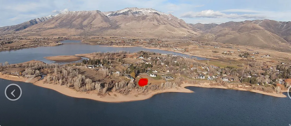 Waterfront property featuring direct shoreline access and established surrounding trees