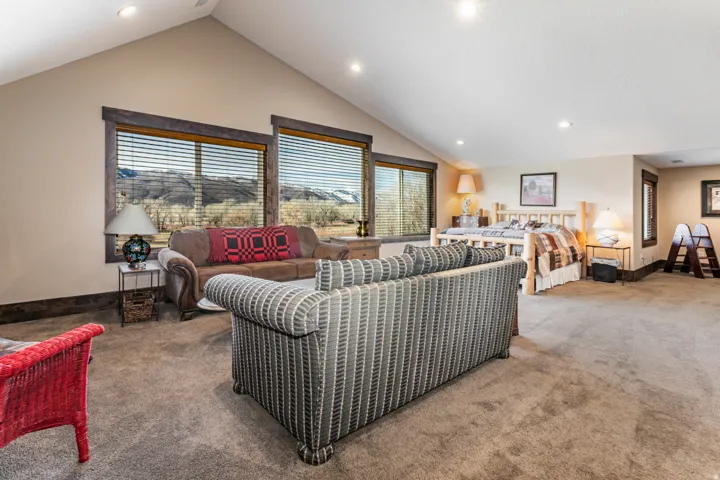 Spacious room with vaulted ceilings and recessed lighting