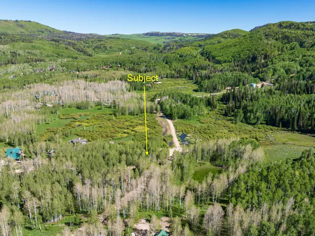 Expansive acreage set amidst rolling hills and dense evergreen forests