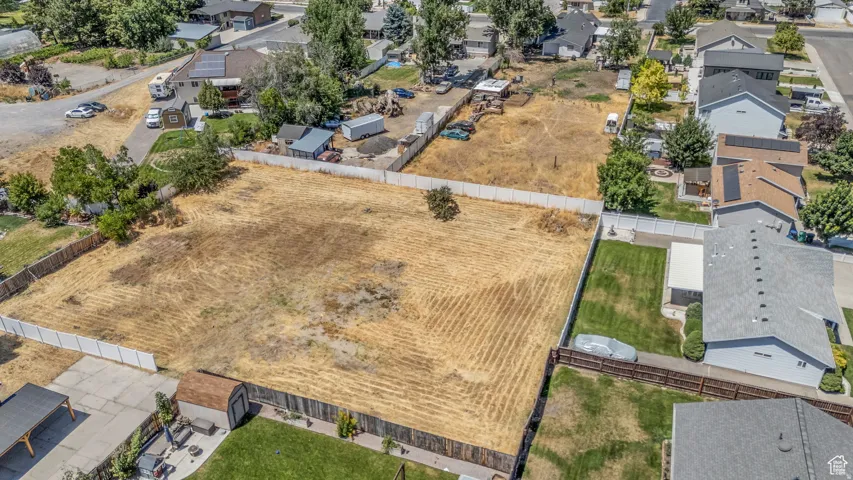 Expansive undeveloped lot featuring perimeter fencing