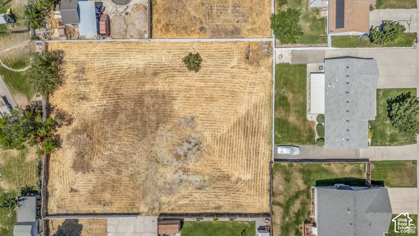 Expansive undeveloped lot with perimeter fencing