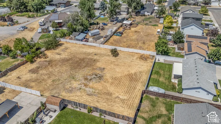 Expansive undeveloped lot featuring perimeter fencing