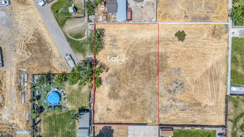 Expansive land parcel identified as "Lot 2," featuring a mostly clear, level terrain with minimal vegetation