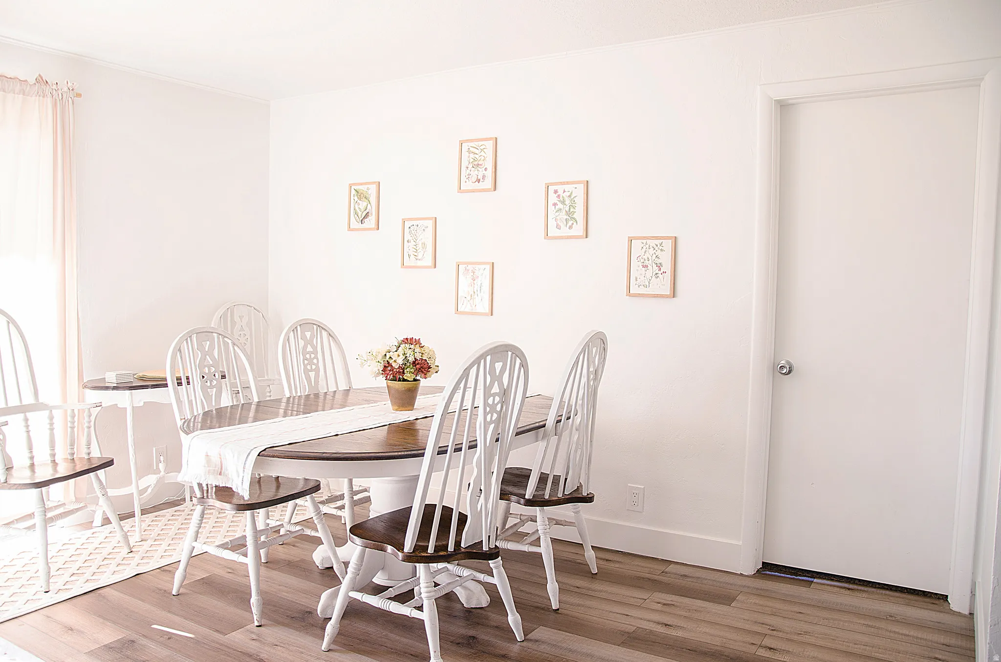 Bright interior space featuring wood-finish flooring and white baseboards